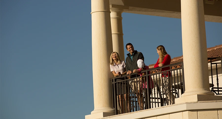 Club members gather on a clubhouse balcony at The Club at Iron Lake in Ocala, Florida.